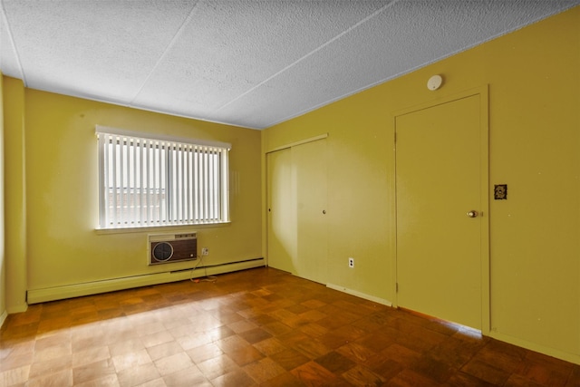 687 Bronx River Rd # 2A, Yonkers, NY 10704 - unfurnished room with a baseboard heating unit, a textured ceiling, a wall unit AC, and a smoke detector