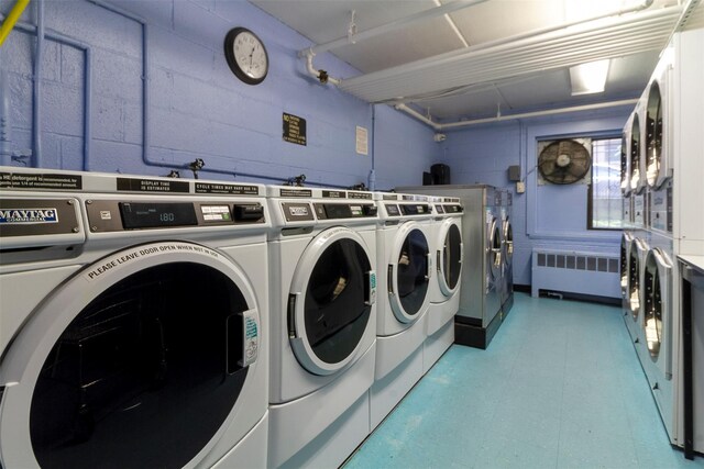 687 Bronx River Rd # 2A, Yonkers, NY 10704 - shared laundry featuring radiator, washing machine and dryer, estacked washer and dryer, light flooring, and concrete block wall