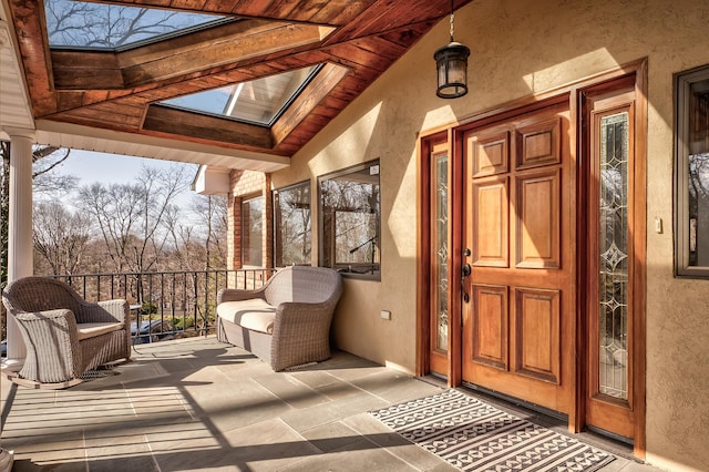 4 Sloanes Ct, Sands Point, NY 11050 - doorway to property with stucco siding and covered porch