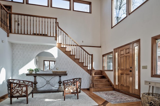 4 Sloanes Ct, Sands Point, NY 11050 - entrance foyer featuring plenty of natural light, baseboards, stairway, and wood finished floors
