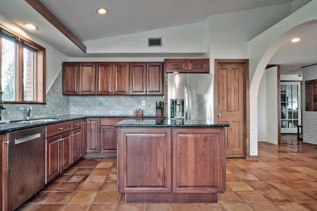 4 Sloanes Ct, Sands Point, NY 11050 - kitchen featuring visible vents, stainless steel appliances, arched walkways, a sink, and vaulted ceiling