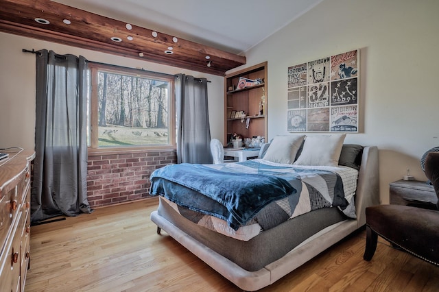 4 Sloanes Ct, Sands Point, NY 11050 - bedroom with vaulted ceiling, light wood-style flooring, and brick wall