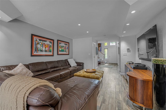living area featuring recessed lighting, a textured wall, stairway, and hardwood / wood-style floors