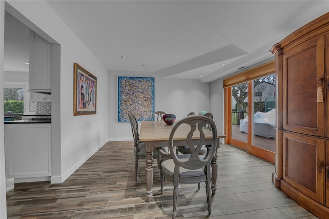 dining room featuring dark wood finished floors, baseboards, and recessed lighting