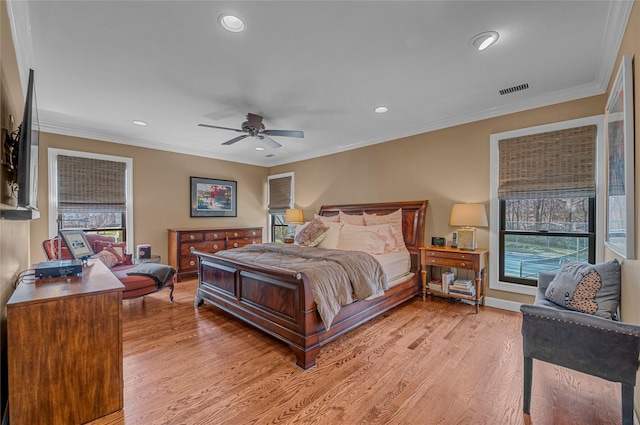 bedroom featuring crown molding, visible vents, and light wood-type flooring
