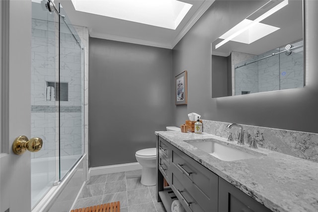 full bath with a skylight, baseboards, ornamental molding, toilet, and vanity