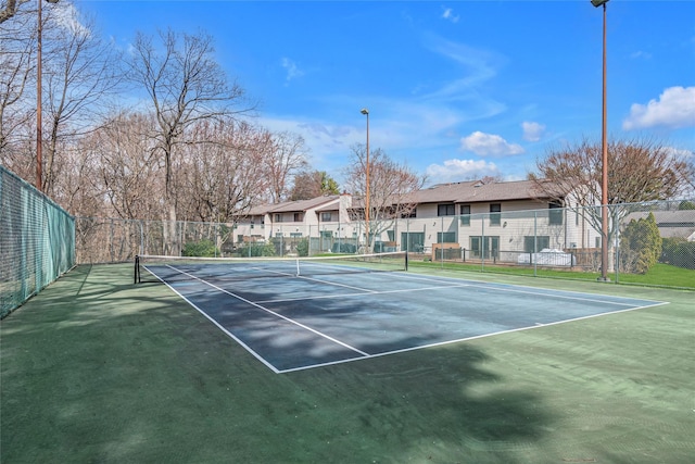 view of sport court featuring a residential view and fence