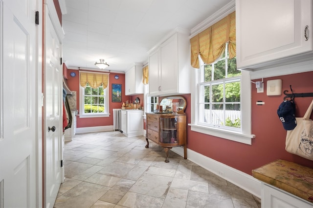 kitchen featuring baseboards and white cabinetry