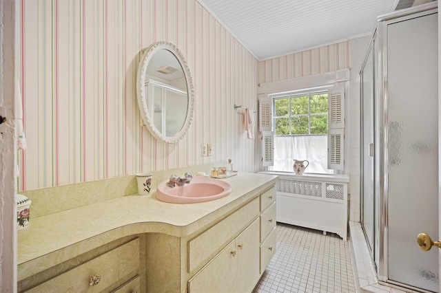 bathroom with a stall shower, tile patterned floors, vanity, radiator, and wallpapered walls