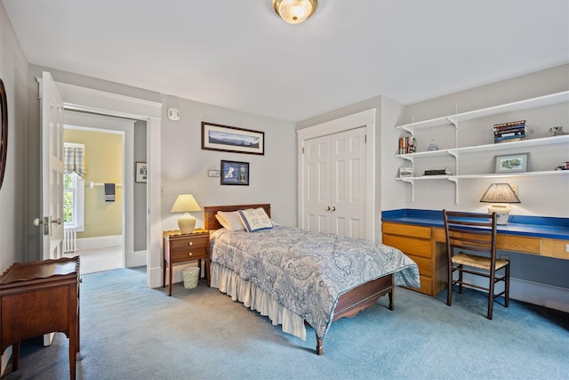 bedroom featuring a closet, baseboards, and carpet