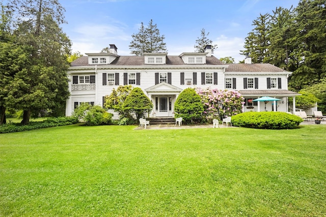 view of front of property with a front lawn and a chimney
