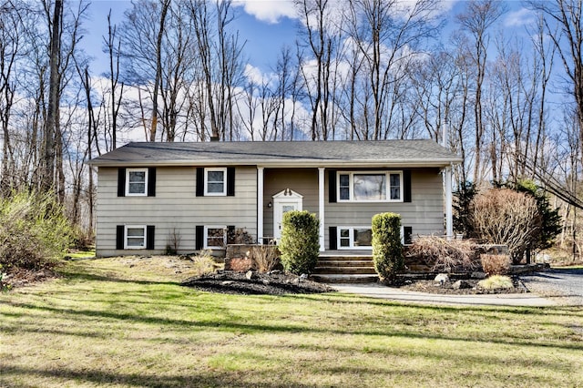 bi-level home featuring a chimney and a front yard