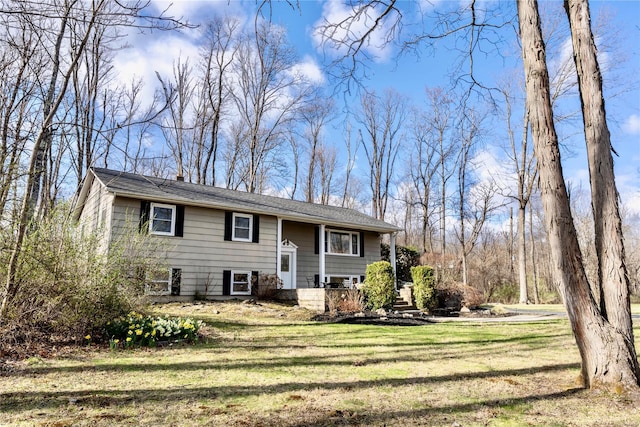 raised ranch featuring a front yard and covered porch