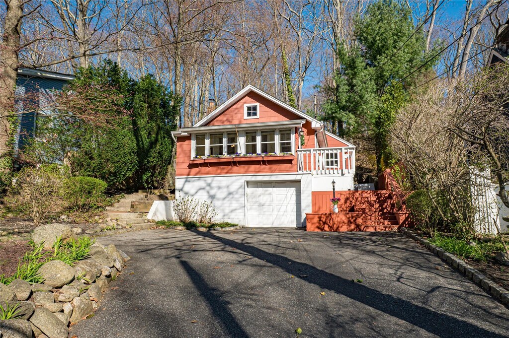 rustic home featuring aphalt driveway