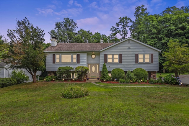 view of front of house with a chimney and a front yard