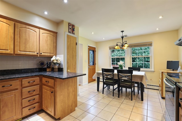 kitchen with backsplash, light tile patterned flooring, decorative light fixtures, and baseboard heating
