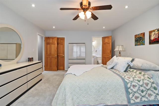 bedroom with recessed lighting, connected bathroom, ceiling fan, and light carpet