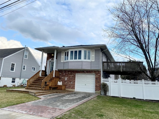 4081 Massachusetts Ave, Island Park, NY 11558 - view of front of property featuring driveway, a front yard, fence, brick siding, and a garage