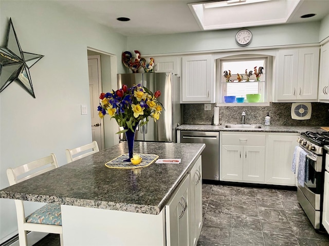 4081 Massachusetts Ave, Island Park, NY 11558 - kitchen with white cabinets, a sink, tasteful backsplash, and appliances with stainless steel finishes
