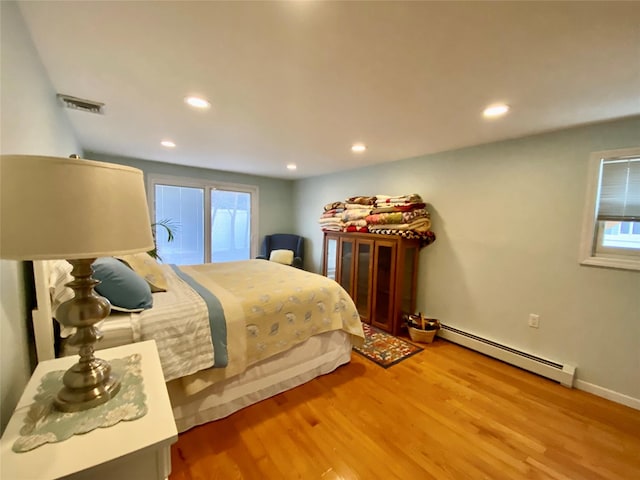 4081 Massachusetts Ave, Island Park, NY 11558 - bedroom featuring visible vents, recessed lighting, a baseboard heating unit, and wood finished floors