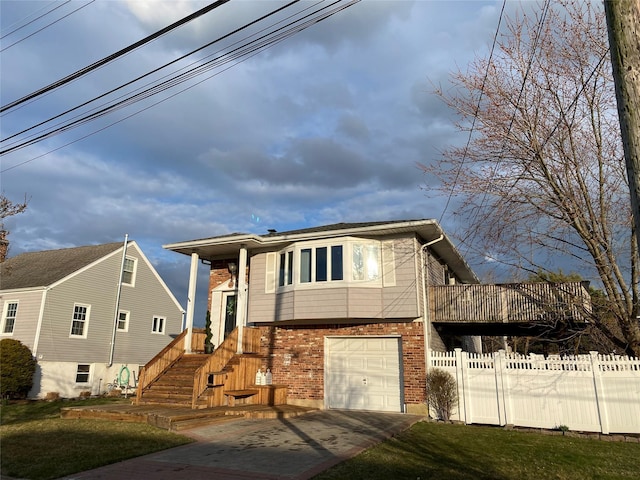 4081 Massachusetts Ave, Island Park, NY 11558 - view of front of home featuring brick siding, fence, concrete driveway, and a garage