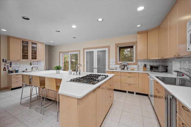 10 Byworth Rd, New Rochelle, NY 10804 - kitchen with light brown cabinets, a sink, stainless steel gas stovetop, backsplash, and recessed lighting