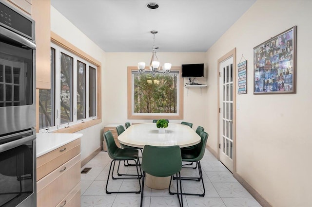 10 Byworth Rd, New Rochelle, NY 10804 - dining space featuring a chandelier and baseboards