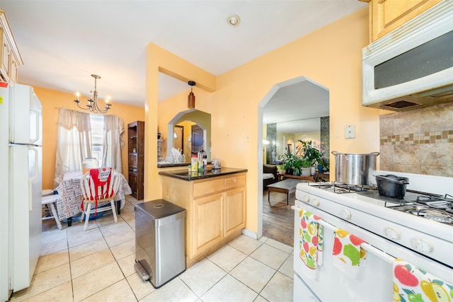 kitchen featuring tasteful backsplash, light brown cabinetry, light tile patterned floors, white appliances, and dark countertops