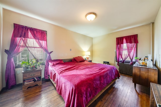 bedroom featuring wood-type flooring and radiator