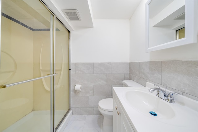 full bathroom featuring tile walls, visible vents, a shower stall, toilet, and vanity