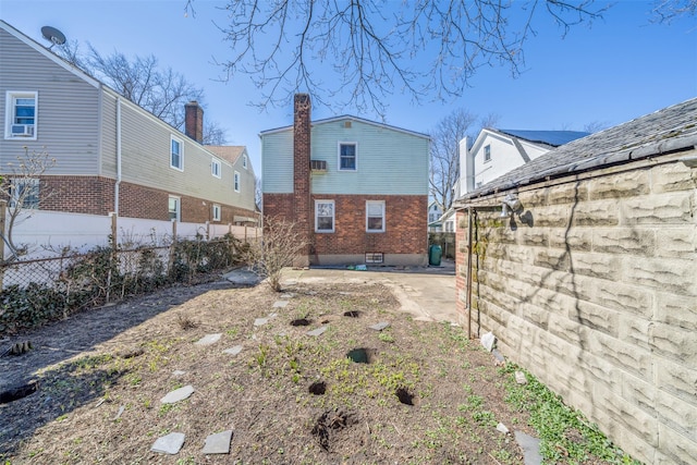 back of property featuring a fenced backyard and a patio area