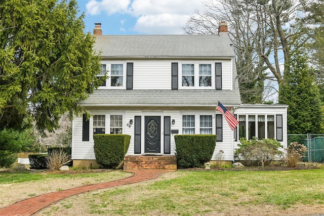 36 Seaview Ave, Northport, NY 11768 - colonial-style house featuring a chimney, a shingled roof, and a front lawn