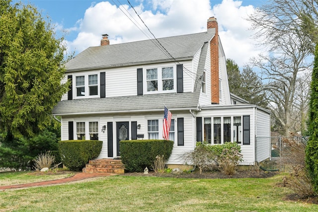 36 Seaview Ave, Northport, NY 11768 - dutch colonial with a front yard, fence, roof with shingles, and a chimney