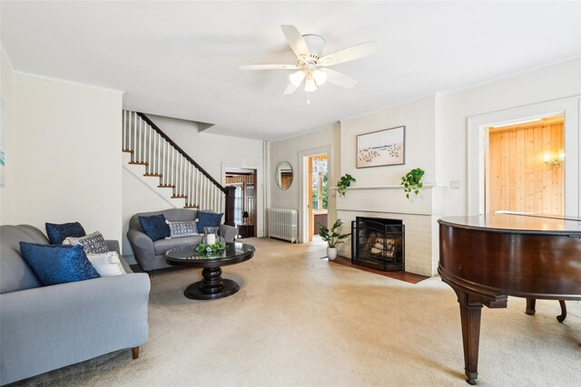 36 Seaview Ave, Northport, NY 11768 - carpeted living room with stairs, a fireplace, radiator heating unit, ceiling fan, and ornamental molding