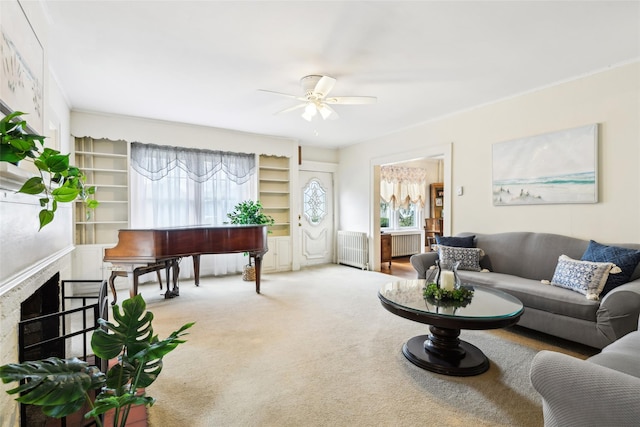 36 Seaview Ave, Northport, NY 11768 - living area with a fireplace, radiator heating unit, ceiling fan, and carpet flooring