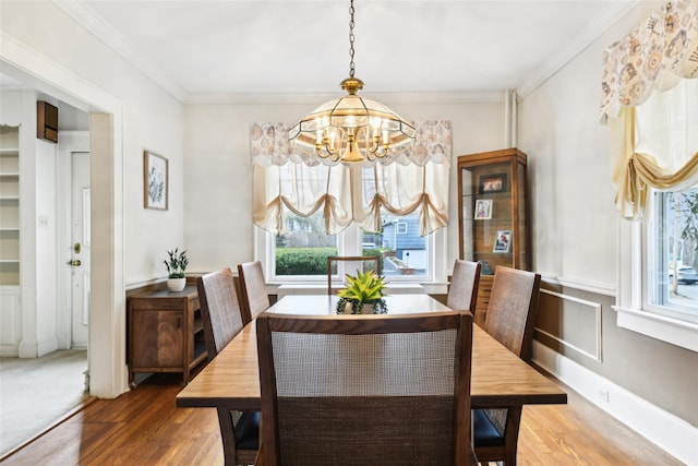 36 Seaview Ave, Northport, NY 11768 - dining room featuring an inviting chandelier, ornamental molding, and wood finished floors