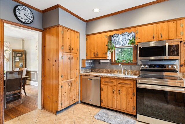 36 Seaview Ave, Northport, NY 11768 - kitchen with light tile patterned floors, a sink, appliances with stainless steel finishes, and crown molding