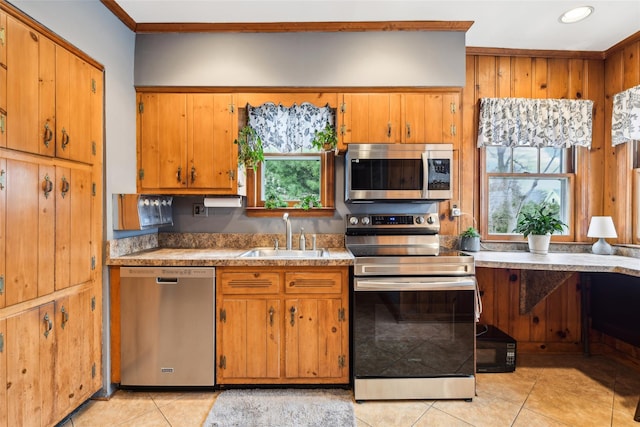 36 Seaview Ave, Northport, NY 11768 - kitchen featuring a sink, appliances with stainless steel finishes, brown cabinetry, and light tile patterned flooring