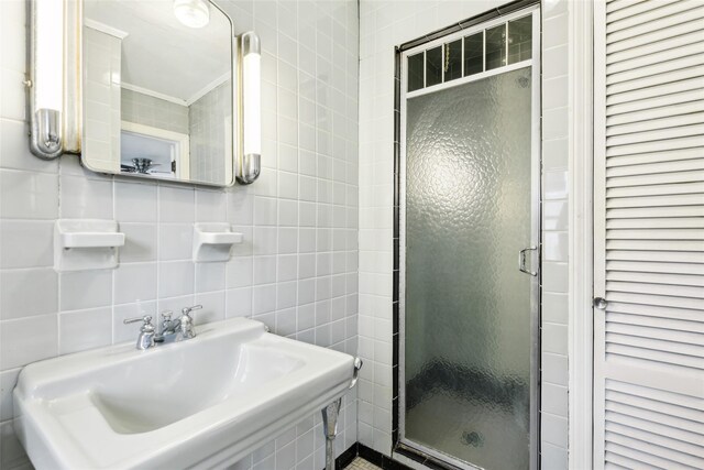 36 Seaview Ave, Northport, NY 11768 - full bath featuring tile walls, a closet, a shower stall, tasteful backsplash, and a sink