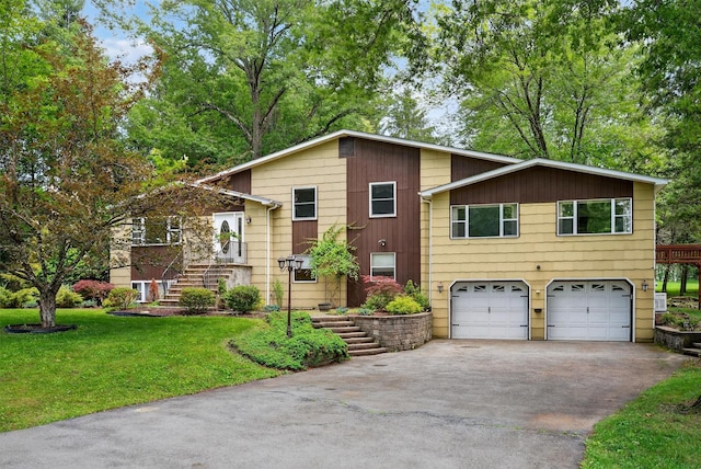 21 Hillside Rd, Slate Hill, NY 10973 - tri-level home featuring stairway, a garage, asphalt driveway, and a front lawn