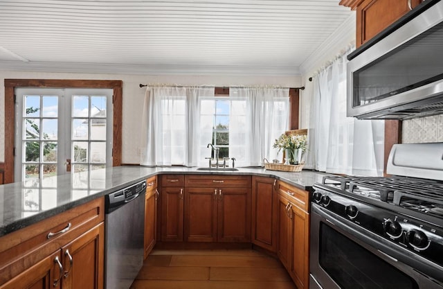 430 Montauk Hwy, East Moriches, NY 11940 - kitchen featuring crown molding, a sink, stainless steel appliances, brown cabinets, and plenty of natural light