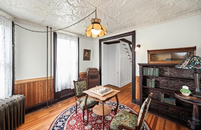 430 Montauk Hwy, East Moriches, NY 11940 - interior space featuring radiator, wood finished floors, wainscoting, stairs, and an ornate ceiling