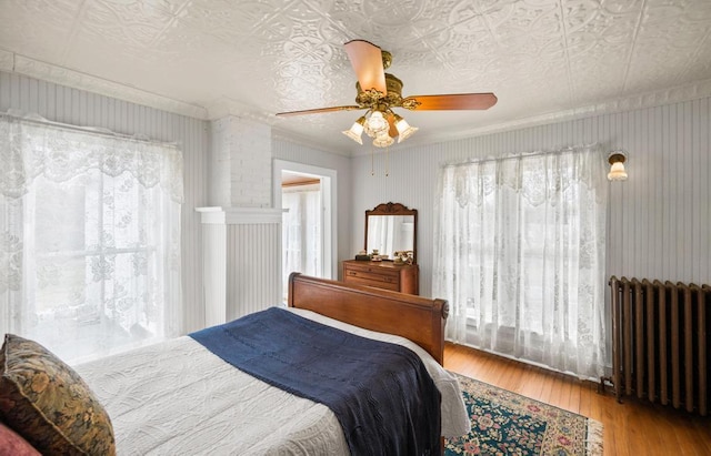 430 Montauk Hwy, East Moriches, NY 11940 - bedroom with an ornate ceiling, radiator heating unit, a ceiling fan, and wood finished floors