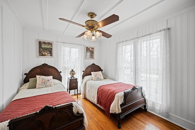 430 Montauk Hwy, East Moriches, NY 11940 - bedroom with light wood-style floors, multiple windows, a ceiling fan, and beam ceiling
