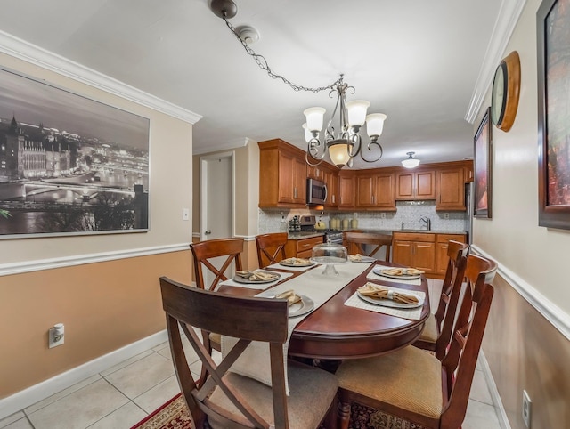 dining room featuring crown molding, light tile patterned floors, baseboards, and a chandelier