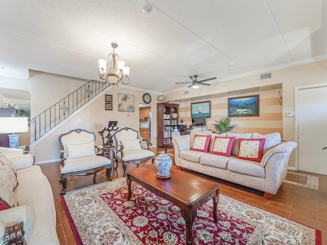 living area featuring wood tiled floor, ceiling fan with notable chandelier, visible vents, and stairs