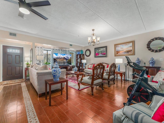 living area with visible vents, a textured ceiling, ceiling fan with notable chandelier, and wood finished floors