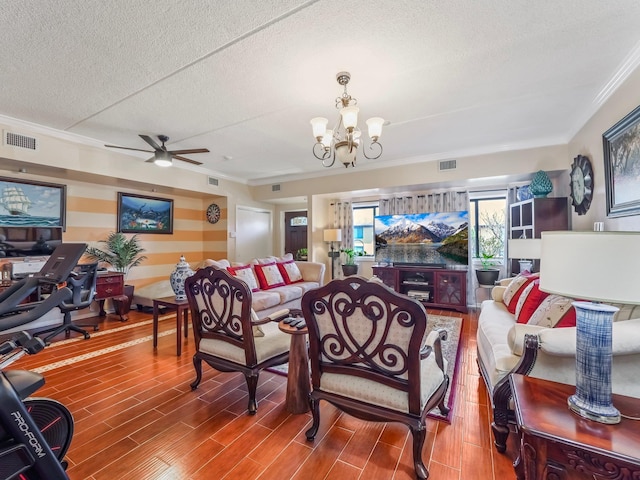 living room featuring ornamental molding, a textured ceiling, visible vents, wood tiled floor, and ceiling fan with notable chandelier