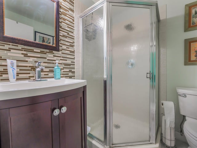 full bathroom with backsplash, toilet, and a shower stall