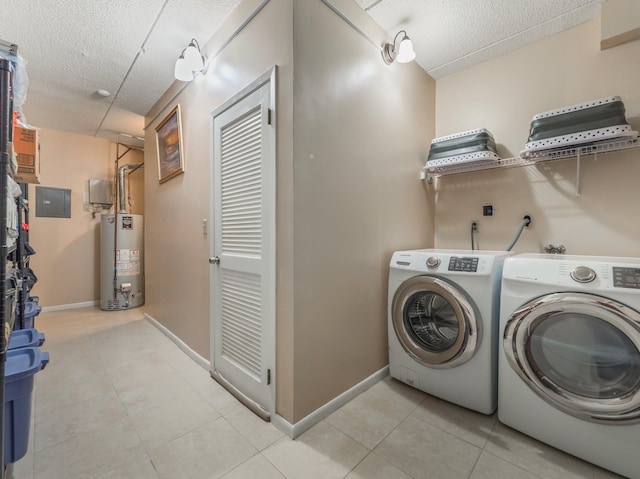 clothes washing area with light tile patterned floors, baseboards, a textured ceiling, water heater, and washing machine and clothes dryer